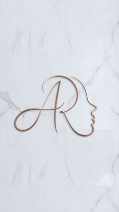 a woman's face is shown with the letter r in gold on a white marble background