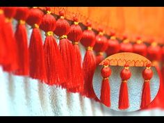 red tassels hanging from the side of a wall