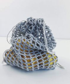 two small crocheted bags sitting next to each other