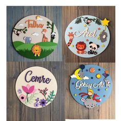 four plates with different designs on them sitting on a wooden surface, each decorated with an animal theme