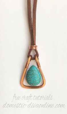 a necklace with a turquoise stone hanging from it's side on a brown cord