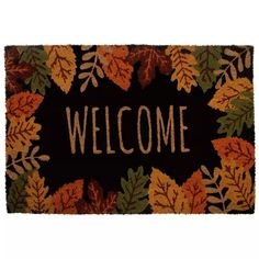 a welcome mat with autumn leaves on it