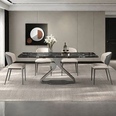 a dining room table with white chairs and a black marble topped centerpiece in the middle