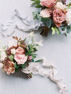 two bouquets of flowers on a white surface