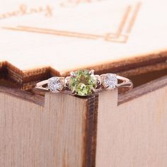 "Simple & dainty 14k rose gold peridot promise ring for her, Elegant 3 stone womens promise ring, Gold 3 stone peridot engagement ring WE OFFER UNLIMITED PERIOD INSTALLMENTS PLAN This is a beautiful, stunning, feminine ring that works well for all occasions, styles, and ages. You will love it! Ring information Main stone: Peridot Approximate size: 4.5mm Accent stone: Cubic zirconia Approximate size: 3mm Metal type: Gold Metal stamp: 14k solid gold Customization / Replacements It's easy to cr Fine Jewelry In Rose Gold With Three Stones, Rose Gold Three Stone Fine Jewelry, Fine Rose Gold Three Stone Jewelry, Peridot Jewelry With Center Stone In Round Cut, Peridot Jewelry With Round Cut Center Stone, Three Stone Peridot Jewelry As Gift, Peridot Three Stone Jewelry As Gift, Anniversary Peridot Jewelry In White Gold, Round Cut Peridot Jewelry With Center Stone