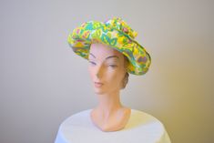 "Vintage 1960s chartreuse/acid yellow straw hat, with printed cotton brim and crown. The crown is gathered at the top and is open on the top. It has an upturned brim. The hat is in good condition -- no holes; it has a few very faint, small spots. The interior circumference is 21\", the brim is 3.25 - 4.5\" wide and the crown is 7\" tall. ---> If you need an order shipped by a particular date or shipped via a quicker method, please ask PRIOR to purchase to see if we can accommodate that reques Retro Green Brimmed Hat, Retro Cotton Sun Hat With Curved Brim, Fitted Retro Green Hat, Retro Fitted Green Hat, Retro Green Bucket Hat, Green Fitted Retro Hat, Green Retro Bucket Hat, Retro Green Wide Brim Hat, Vintage Cotton Sun Hat With Curved Brim