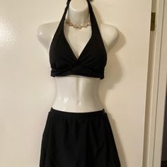 Black Halter Swim Top With Sewn In Pads By Catalina. Ties Around Neck And Back. Size M (8-10). Tried On But Never Worn In Water. Unbranded Black Swim Skirt - Never Worn. Elastic Waist Measures 12 1/2”. Full Coverage Lined Bottoms. Black V-neck Lined Swimwear, Black Lined V-neck Swimwear, Chic Black Tankini With Built-in Bra, Elegant Fitted Halter Top For Vacation, Black Swim Dress With Built-in Bra For Beach Season, Elegant Halter Top For Poolside, Elegant Fitted Halter Top For Poolside, Fitted Black Swimwear For Beachwear, Fitted Black Beachwear Swimwear