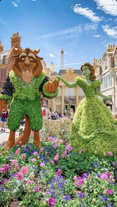 the beauty and the beast topiaries in front of the eiffel tower