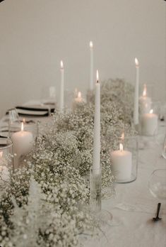 the table is set with candles and flowers