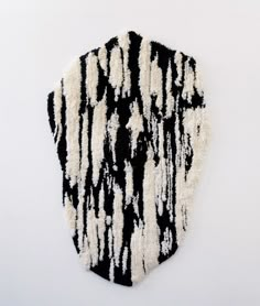 a black and white piece of art that looks like it has been made out of yarn