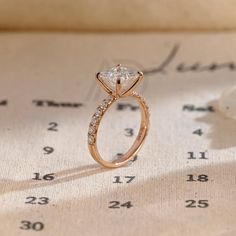 a diamond ring sitting on top of a table