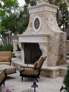 an outdoor fireplace surrounded by furniture and trees