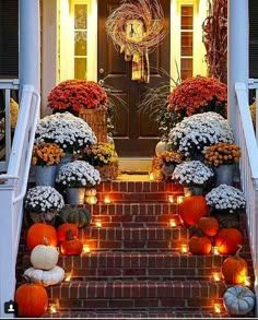 an entry way decorated with pumpkins and flowers