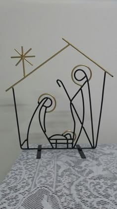 the nativity scene is made out of wire and has three wise men in it