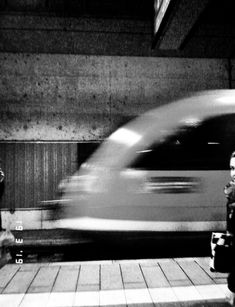 a blurry photo of a person waiting at a train station