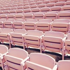 rows of pink seats in an empty stadium