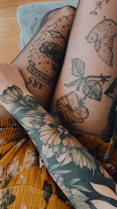 a woman's legs with tattoos on them