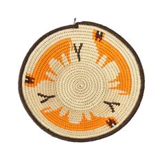 an orange and white woven basket with arrows