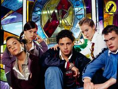 a group of people sitting next to each other in front of a stained glass window