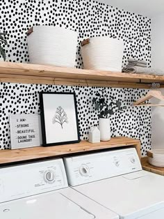 a white washer and dryer sitting next to each other in a laundry room