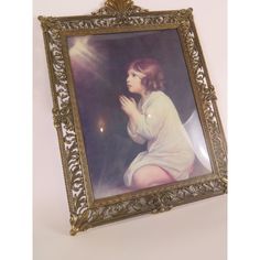 an old framed photograph of a woman praying