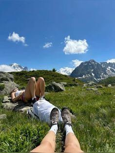 a person laying on top of a lush green field