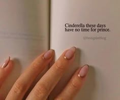 a woman's hand holding an open book with pink nail polish on it and the words cinderella these days have no time for prince