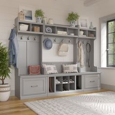 a large white rug in front of a gray and white coat rack with many items on it