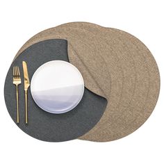 a plate, fork and knife are on a placemat with two plates next to each other