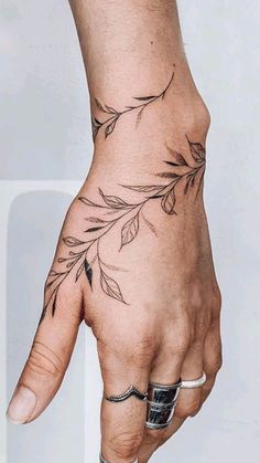 a person's hand with a tattoo on it