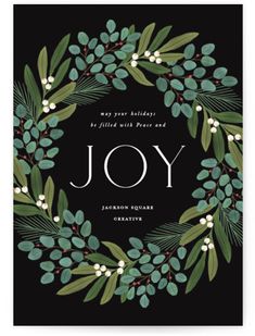 the joy holiday card features an evergreen wreath with berries and mists on black background