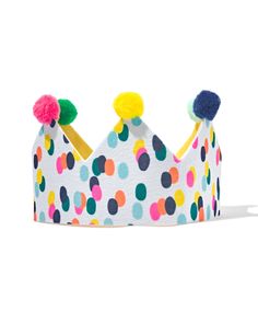 a colorful polka dot crown with pom poms