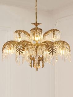 a chandelier hanging from the ceiling in a room with white walls and doors