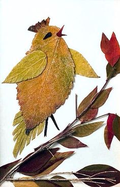 a yellow bird sitting on top of a leaf covered branch next to red and green leaves