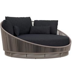 a modern daybed with black cushions and pillows on it's backrests