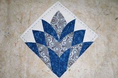 a blue and white patchwork design on a piece of cloth