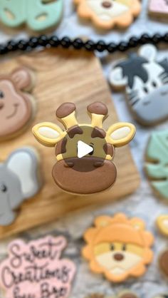 an animal themed cookie is being displayed on a table with other cookies in the background