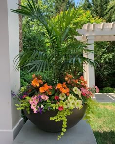 a large planter filled with lots of colorful flowers