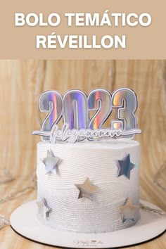 a white cake with silver stars on top and the number twenty two in front of it