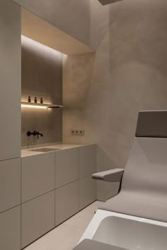 a modern bathroom with sink and bathtub in the middle of it's walls