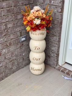 a welcome to our home sign with flowers in it