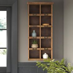 a wooden shelf with some plants in it