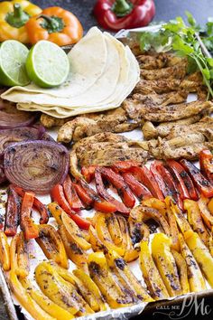 an assortment of vegetables and meats on a platter with tortilla wrappers