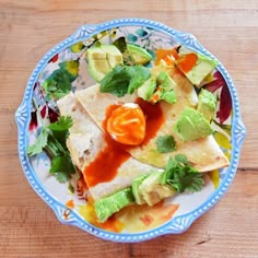 a blue and white plate topped with tortillas covered in guacamole