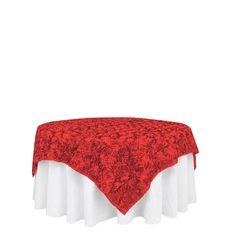 a red and white table cloth on top of a round tablecloth with rose patterns