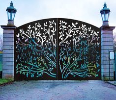 an iron gate with trees painted on it