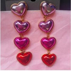 Multi Heart Earrings Covered In Pink,Red,And Purple Vegan Leather With Gold Tone Details. Each Earring Measures Almost 3 Inches Long! Post Style Backs. Vintage Deadstock. Never Worn, In Perfect Condition! Still In Original Packaging! Perfect For Valentines Day, Mardi Gras,Halloween, Or Any Day You Feel Like Wearing Some Metallic Hearts! #Barbie #Hearts #Valentinesday #Halloween #Costume #Vintagejewelry #Vintageearrings #Barbiecore #Glam #Feminine #Metallicleather #Clubwear #Festivalwear Barbiecore Jewelry, Retro Heart Earrings For Valentine's Day, Vintage Heart-shaped Earrings For Party, Vintage Pink Heart Earrings For Valentine's Day, Vintage Heart Charm Earrings For Valentine's Day, Retro Heart-shaped Jewelry For Valentine's Day, Valentines Fashion, Red And Purple, Heart Shaped Earrings