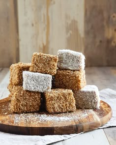 some sugar cubes are stacked on top of each other in front of a wooden board