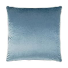 a blue velvet pillow on a white background