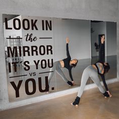 two women doing yoga in front of a mirror with the words look in the mirror it's you vs you